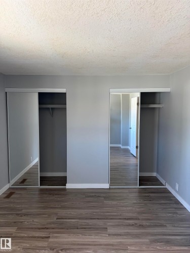 Bedroom featuring wood-finish flooring, light gray wall paint, and white trim - 14075 30 Street E, Edmonton, AB - Indoor Photo Showing Other Room