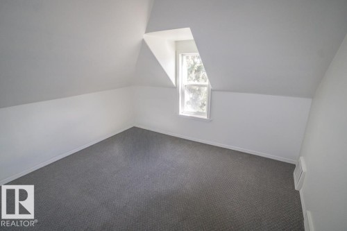 Room featuring a dormer window, neutral wall paint, white trim, and gray carpeting - 4814 51 Ave, St. Paul Town, AB - Indoor Photo Showing Other Room