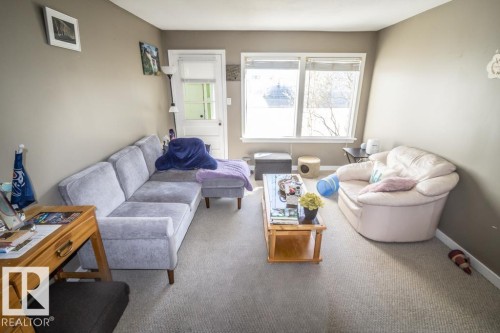 Living area featuring a light gray wall color, neutral carpet flooring, and white trim - 4814 51 Ave, St. Paul Town, AB - Indoor Photo Showing Living Room