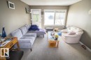 Living area featuring a light gray wall color, neutral carpet flooring, and white trim - 4814 51 Ave, St. Paul Town, AB  - Indoor Photo Showing Living Room 
