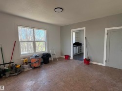Spacious room featuring neutral painted walls, a large window. - 