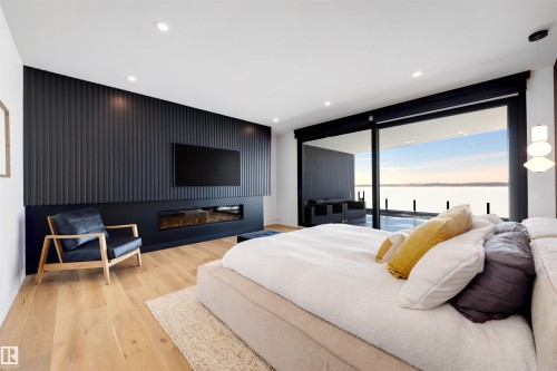 71 Birchcliff Road, Birchcliff, AB - Indoor Photo Showing Bedroom With Fireplace