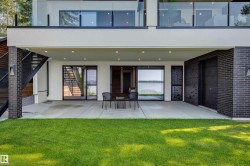 Expansive concrete patio with recessed lighting, overlooking a body of water - 