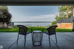 Expansive concrete patio offering broad views of the lake - 