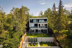 Modern multi-level residence featuring expansive balconies with glass railings - 