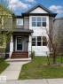 Two-story residence featuring a dark gray and white exterior with diverse siding textures including horizontal panels, shake, and stone accents - 2143 32 Street, Edmonton, AB  - Outdoor With Facade 