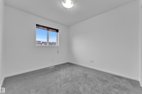 Room with neutral gray carpeting and white walls - 2143 32 Street, Edmonton, AB - Indoor Photo Showing Other Room