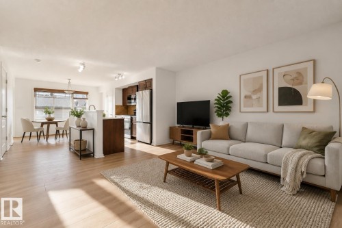 Bright living area featuring wood-finish flooring and a neutral color palette - 2143 32 Street, Edmonton, AB - Indoor Photo Showing Living Room