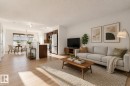 Bright living area featuring wood-finish flooring and a neutral color palette - 2143 32 Street, Edmonton, AB  - Indoor Photo Showing Living Room 
