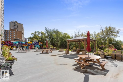 Patio space featuring Gazebo, BBQ Area, Tables, Community Garden & a Colourful Mural - 602 12303 Jasper Avenue, Edmonton, AB - Outdoor