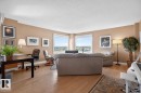 Open concept living area with hardwood flooring, corner windows.  West & South Facing Views; - 602 12303 Jasper Avenue, Edmonton, AB  - Indoor Photo Showing Living Room 