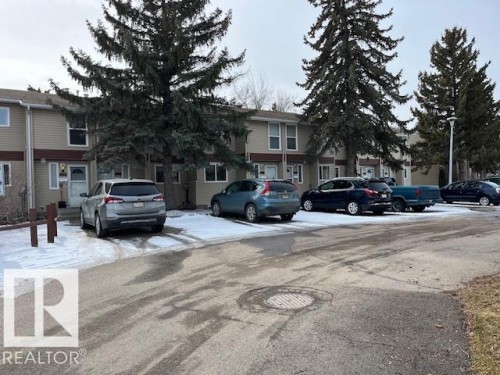 This property features a multi-level design with light-colored siding and a dark roof - 350 Clareview Road, Edmonton, AB - Outdoor With Facade