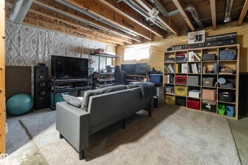 Finished lower level space featuring exposed ceiling joists, ductwork, and utility lines - 2 13403 Cumberland Road, Edmonton, AB - Indoor Photo Showing Basement