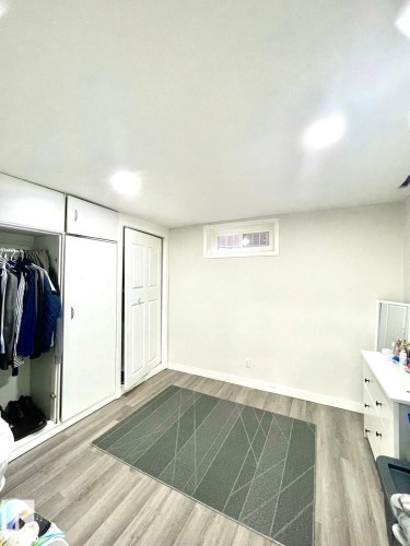 Room featuring wood-finish flooring, recessed ceiling lighting, and a white baseboard trim - 8620 137 Avenue, Edmonton, AB - Indoor Photo Showing Other Room