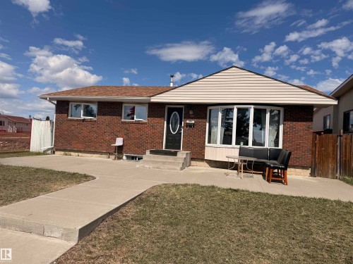 Brick exterior featuring a prominent bay window with white trim - 8620 137 Avenue, Edmonton, AB - Outdoor