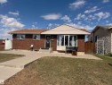 Brick exterior featuring a bay window and a covered entry - 8620 137 Avenue, Edmonton, AB  - Outdoor 