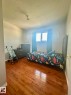 Hardwood flooring extending throughout the space - 8620 137 Avenue, Edmonton, AB  - Indoor Photo Showing Bedroom 