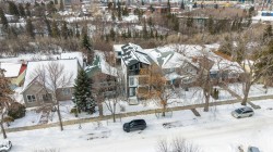 The property features a distinctive dark-colored exterior with white trim and a prominent peaked roofline - 