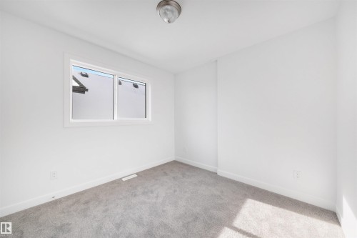 This room features a neutral color palette with white walls and gray carpet - 7927 112S Avenue, Edmonton, AB - Indoor Photo Showing Other Room