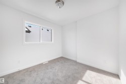 This room features a neutral color palette with white walls and gray carpet - 