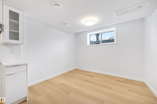 Bright room featuring light wood flooring, white walls, and a window with a view - 7927 112S Avenue, Edmonton, AB - Indoor Photo Showing Other Room