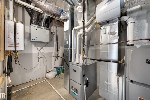 The property features a comprehensive utility area with a water heater, furnace, and extensive ductwork, ensuring efficient operation - 7927 112S Avenue, Edmonton, AB - Indoor Photo Showing Basement