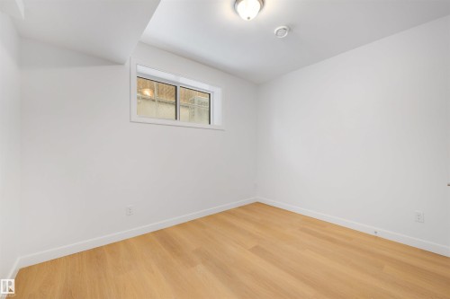 Room featuring light wood flooring, white walls, and a window providing natural light - 7927 112S Avenue, Edmonton, AB - Indoor Photo Showing Other Room