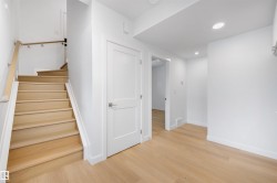 Entryway featuring light hardwood flooring, a white interior door, and recessed lighting - 
