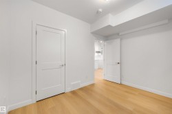 This room features light hardwood flooring, white walls, and white trim - 