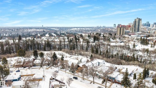 The property is located in a neighborhood featuring residential streets with snow-covered homes and trees - 7927 112S Avenue, Edmonton, AB - Outdoor With View