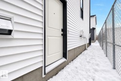 White horizontal siding with a contrasting black trim door frame - 