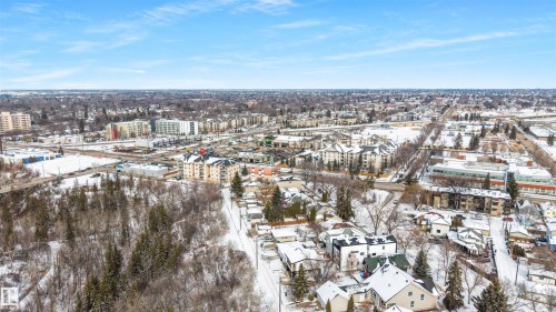 Aerial view showcasing the surrounding neighborhood with various buildings and snow-covered terrain - 7927 112S Avenue, Edmonton, AB - Outdoor With View