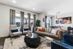 Open-concept living area featuring dark wood-finish flooring and recessed lighting - 