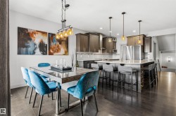 Expansive open-concept living area featuring dark wood-finish flooring - 