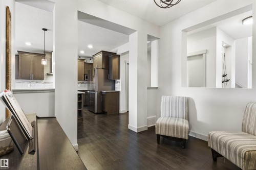 Open-concept interior featuring dark wood-finish flooring throughout - 7343 Armour Crescent, Edmonton, AB - Indoor Photo Showing Other Room