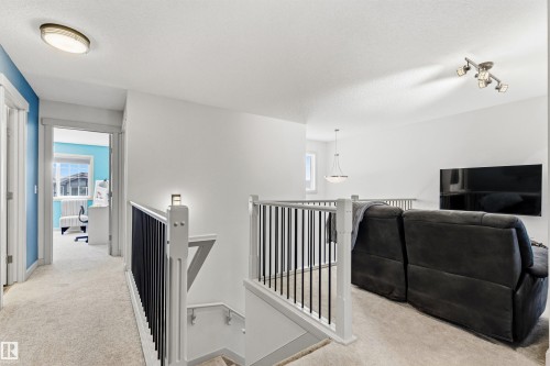 Open-concept upper level featuring neutral carpet. - 7343 Armour Crescent, Edmonton, AB - Indoor Photo Showing Other Room