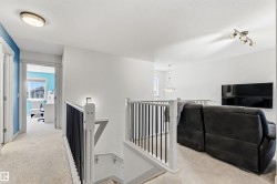 Open-concept upper level featuring neutral carpet. - 