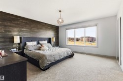Spacious room featuring a prominent wood-finish accent wall, large window with expansive outdoor scenery. - 