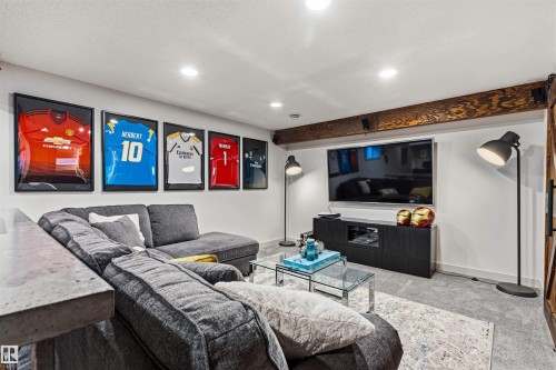 Recreational space featuring recessed lighting, a wood beam and media area. - 7343 Armour Crescent, Edmonton, AB - Indoor Photo Showing Living Room