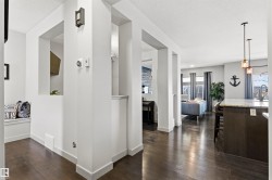 Open concept living space featuring wood-finish flooring throughout, a built-in bench alcove with cubby storage, and recessed wall cut-outs - 