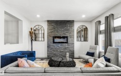Living area featuring a textured stone fireplace surround with an integrated linear electric fireplace - 