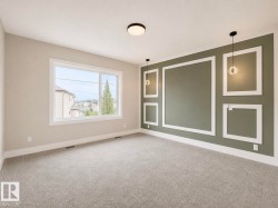 Accent wall with decorative molding and two pendant lights - 
