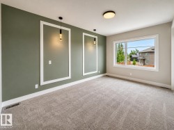 Room featuring a statement wall with decorative molding and pendant lighting - 