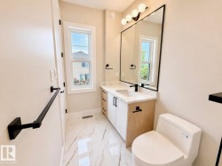 Contemporary bathroom with a single vanity, a white countertop, and integrated sink - 