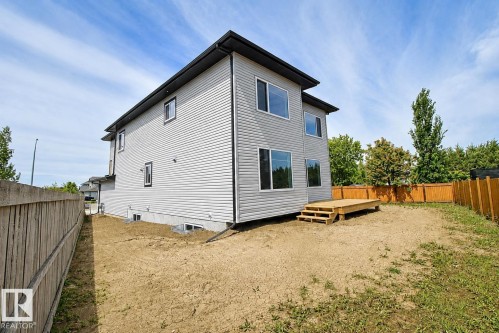 Contemporary two-story exterior with light gray siding and dark trim - 16 Middleton Close, Leduc, AB 