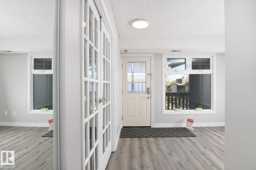 Entryway with light wood-finish flooring, white walls, and a white ceiling - 5816 172 Street, Edmonton, AB - Indoor Photo Showing Other Room
