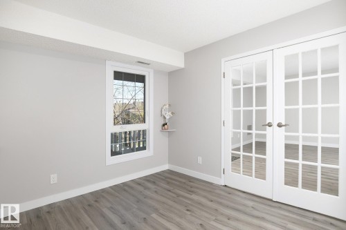 French doors with lites opening to an interior space - 5816 172 Street, Edmonton, AB - Indoor Photo Showing Other Room