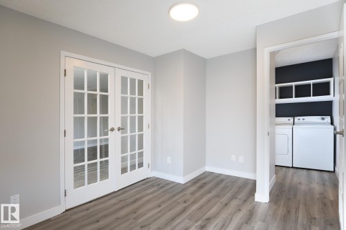 Interior space featuring wood-finish flooring, light gray wall paint, and white trim - 5816 172 Street, Edmonton, AB - Indoor Photo Showing Other Room