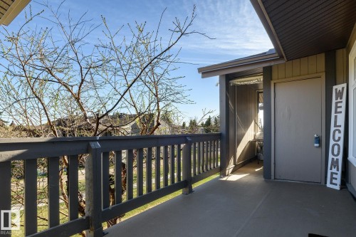 Entryway porch with a solid-panel door, vertical siding, and an overhead awning - 5816 172 Street, Edmonton, AB - Outdoor