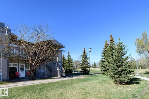 Exterior property featuring a second-story balcony, visible ground-level patio, and exterior stairs - 5816 172 Street, Edmonton, AB - Outdoor